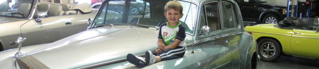 a child sits on a Jaguar at our Dublin auto repair facility