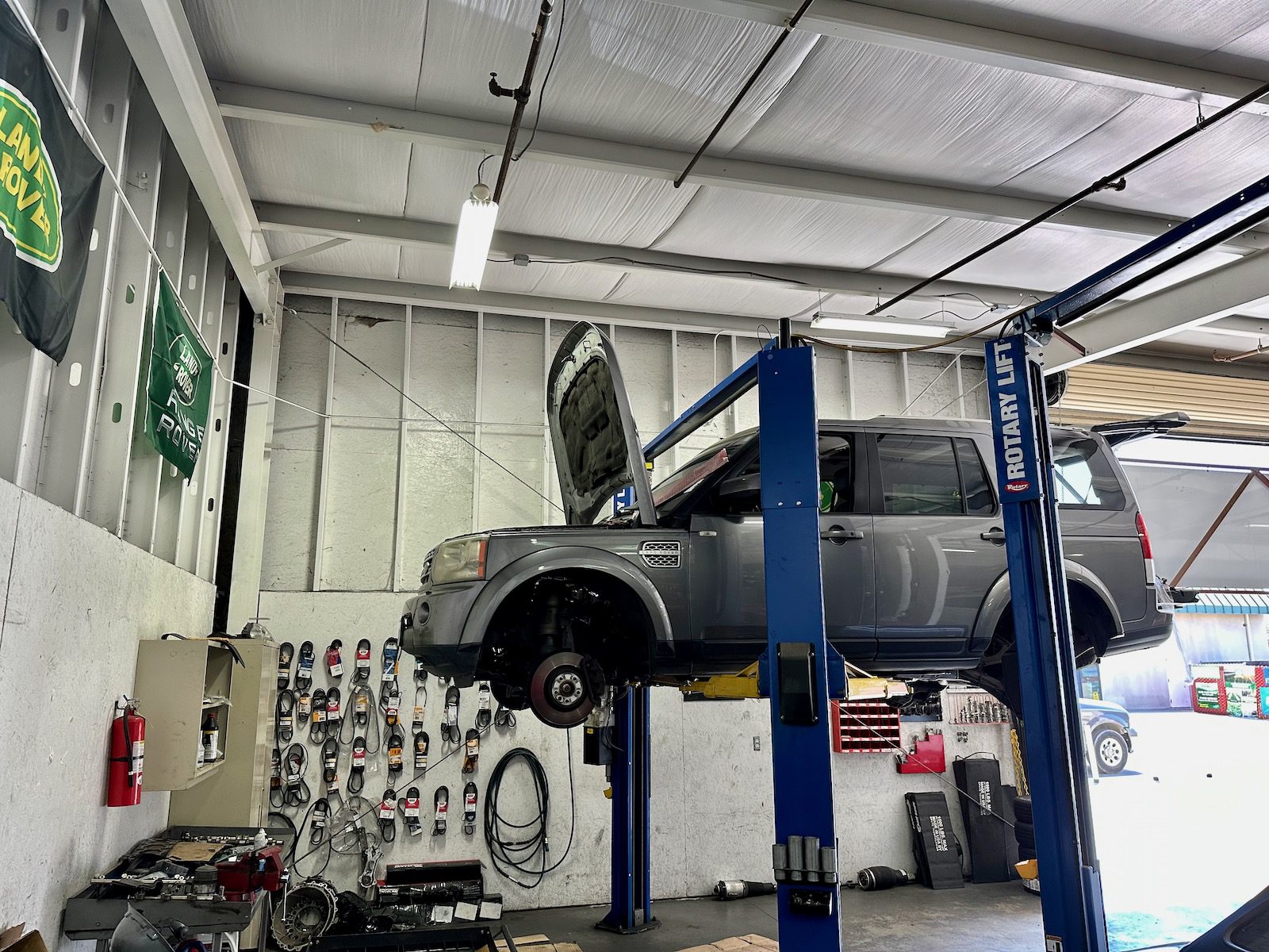 Bacchus British Land Rover On Lift Being Repaired